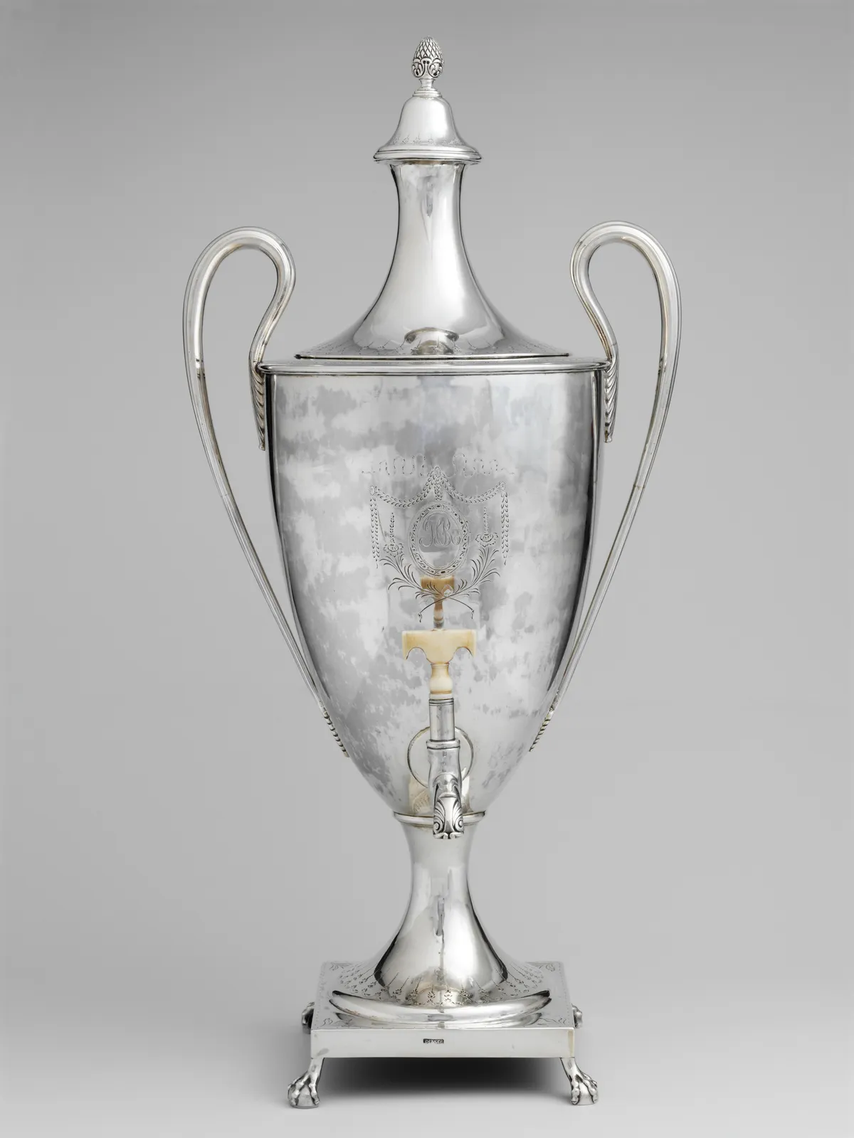 Cultural archive image of “Tea Urn”, catalogued as American, dating to 1791, associated with Boston, Massachusetts, United States. Medium: Silver, ivory. Dimensions: Overall: 22 1/4 x 10 5/8 x 10 3/8 in.