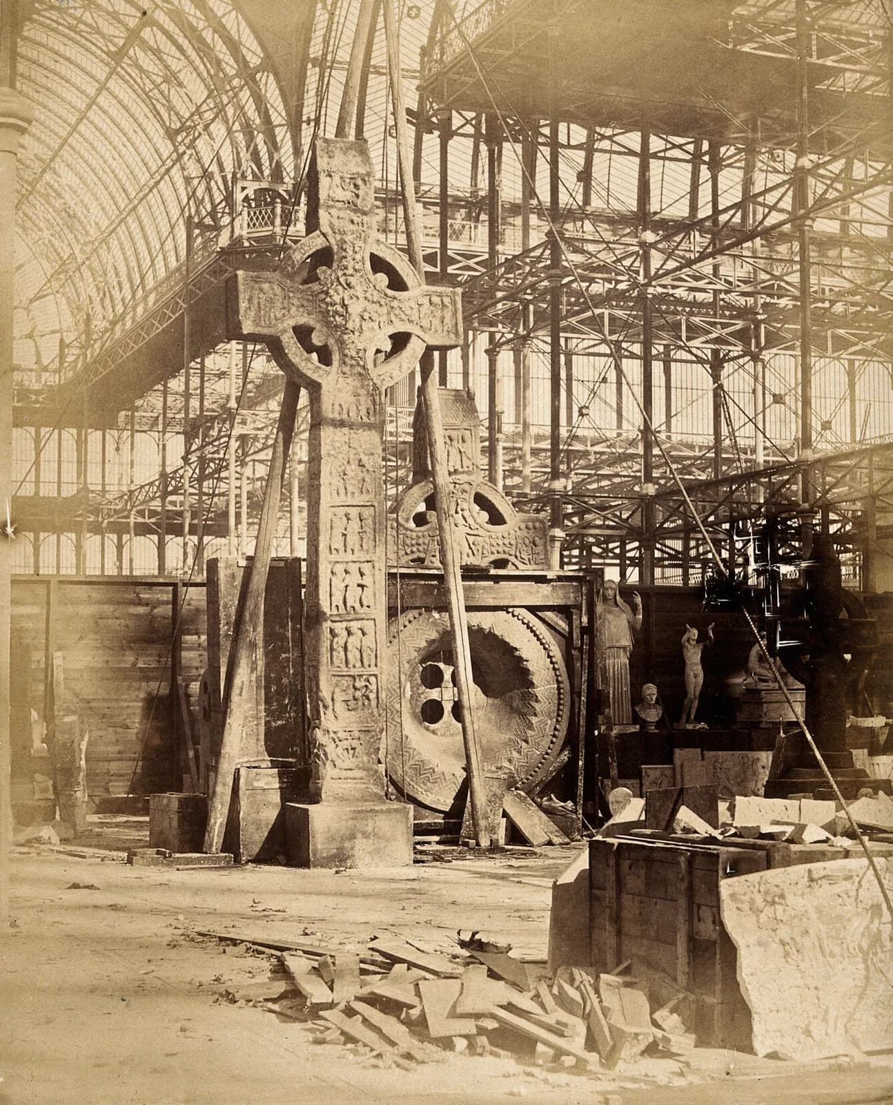 The Crystal Palace during its re-erection at Sydenham, London: a large celtic cross and other statues in the unfinished interior. Photograph by Philip Delamotte, ca. 1854.